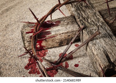 Crown Of Thorns, Wooden Cross, Nails And Blood Drops On Sand. Jesus Christ's Sacrifice And Atonement Of Our Sins