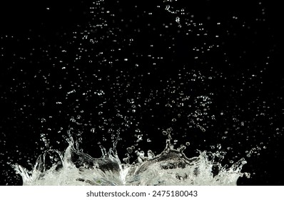 Crown water to object make curve drop explosion in ripple motion. Black background isolated. Crown Water splash on object to create shape form fluttering in droplet and wave. 