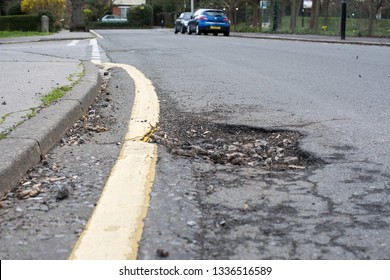 Croydon, Greater London, UK- March 2019: A Big Pot Hole In London Which Is Closer To The Kerb On The Yellow Line Posing A Risk To Cyclist And Other Road Users