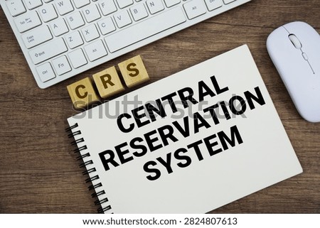 CRS Central Reservation System message with keyboard and optical mouse on wooden background
