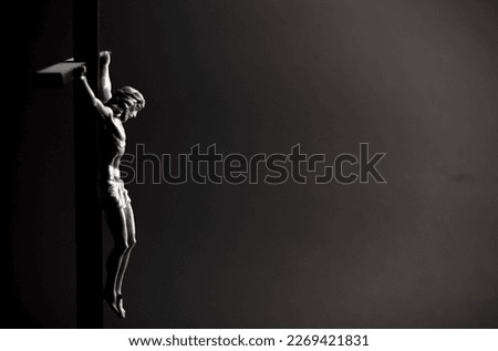 crucifix with crucified christ in black and white, space for text burial