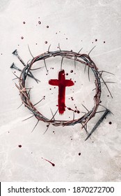 Crucifix made of blood, crown of thorns. Good friday. Easter holiday. Christian cross painted with blood on stone background. Passion, crucifixion of Jesus Christ. Gospel, salvation concept.
