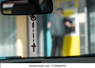 Crucifix On Mirror's Car ,man In Blur  Using An ATM 