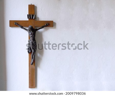 Crucifix on wall of old church. Catholic crucifix with text space.
