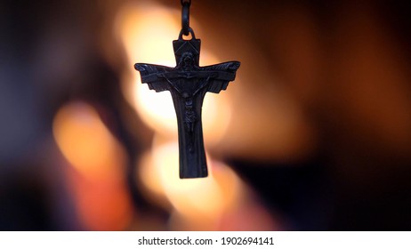 Crucifix Silhouette on Fire Flames Defocused Dark Background Slow Motion