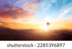 The crucifix symbol of Jesus on the mountain sunset sky background