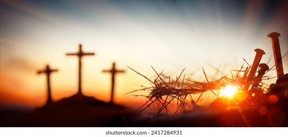Crucifixion Calvary - Crown Of Thorns And Bloody Spikes At Sunset With Crosses On Hill -  Focus On Foreground With Sunlight And Flare Effects