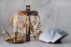 Crucifixion Cross, Candle And Biblical Book Close Up On Table. Easter, Orthodox Palm Sunday. Good Friday. Symbol Of Christianity, Faith, Lent, Prayer. Church Religious Holiday.