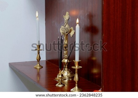 Crucifixion cross, candle close up on table. symbol of faith in God, Christianity Feast, Easter, Palm Sunday, Lent. Religious church holiday 