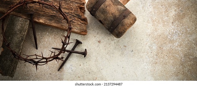 Crucifixion Of Jesus Christ. Cross With three Nails And Crown Of Thorns on ground