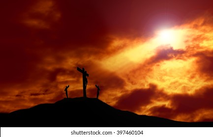 Crucifixion of Jesus on a cross against a dramatic sunset with rays of light breaking through the clouds onto the cross and lens flare for effect. Concept of Good Friday and Easter Sunday. Copy space.