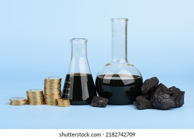 Crude Oil In Glass Beakers And Black Hard Coal Lumps With Coins Stacks On Blue Background, Fossil Fuel Price Concept