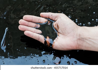 Crude Oil In Hand Due To Crude Oil Leak.crude Oil Low Price Concept.