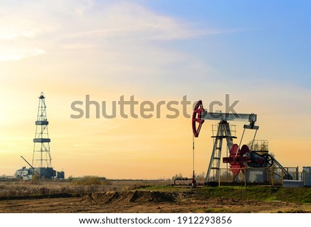 Crude oil pump jack at oilfield on atmospheric sunset backround. Fossil crude output and fuels oil production. Oil drill rig and drilling derrick. Global crude oil Prices, energy, petroleum demand Stock fotó © 