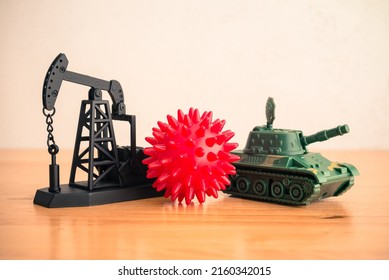 Crude Oil Pumpjack, Covid-19, Battle Tank Model On Wooden Table Background. Concept Of Global Economy Crisis Due To Energy Price Increase, Coronavirus Pandemic And War.