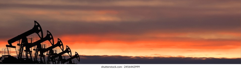 Crude oil Pumpjack on oilfield on sunset, banner for website. Fossil crude production. Oil drill rig and drilling derrick. Global crude oil Prices, petroleum demand OPEC+. Pump jack, oilfield - Powered by Shutterstock