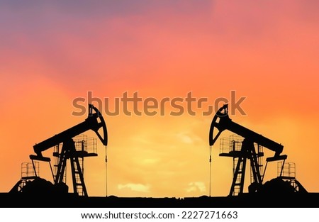 Crude oil Pumpjack on sunset. Fossil crude output and fuels oil production. Oil drill rig and drilling derrick. Global crude oil Prices, energy, petroleum demand (OPEC+). Pump jack at oilfield.