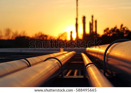 crude oil refinery during sunset with pipeline connection