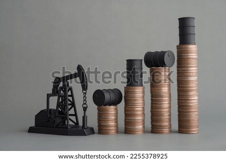 Crude oil tank on stack coin as price chart graph rising up and pump jack on grey background. World petroleum and energy industry or trading commodity investment, crude oil and gas price increase.