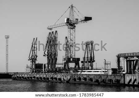 Similar – Pastel evening atmosphere at the harbor basin with cargo cranes