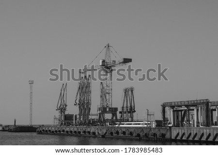 Similar – Pastel evening atmosphere at the harbor basin with cargo cranes