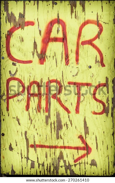 A\
crude, old sign advertising the sale of car\
parts.