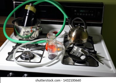 Crudely Constructed Meth Lab On A Stove Top Consisting Of Crushed Nasal Decongestant Pills, Mysterious Solutions, A Red Powder, Pots And Pans, And Hoses