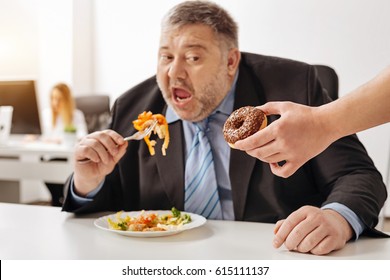 Cruel Colleagues Teasing Obese Man With Sweets