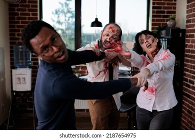 Cruel Spooky Zombies Chasing After Businessman, Frightened Person Running From Brain Eating Bloodthirsty Monsters. Scared Man Being Afraid Of Undead Aggressive Corpses, Walking Dead.