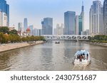 Cruise boat with tourists in the financial district of Tianjin, China