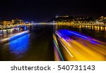 Cruise Boats Danube River Passing Under Chain Bridge Night Budapest Hungary.  Elizabeth Bridge in the distance