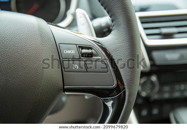 cruise control system button in steering wheel of\
modern car close up