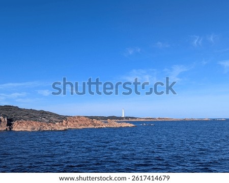 Cruise to lighthouse at Hells Gate on mouth of Macquarie harbour in Southwest Tasmanian Wilderness Area near Strahan on a sunny day - Australia