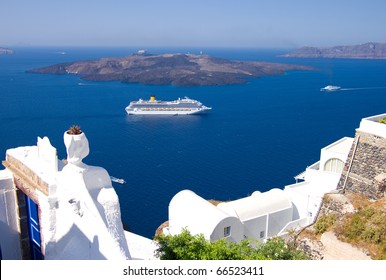 Cruise Liner Motoring Into The Caldera Below The Cliffs Of The Capital City Of Fira On The Greek Island Of Santorini