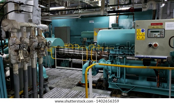 Cruise\
ship engine room interior with water tight doors electrical and\
diesel engines, water pipes, measuring\
instruments