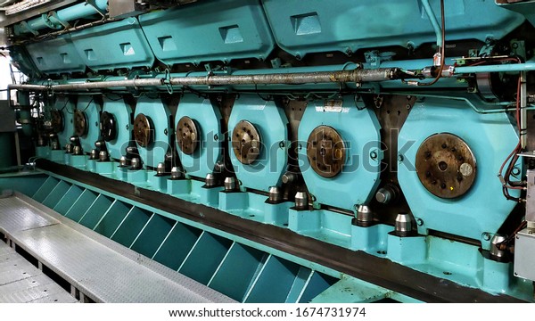 Cruise ship engine room interior with water tight\
doors electrical and diesel engines, water pipes, measuring\
instruments, diesel\
engines
