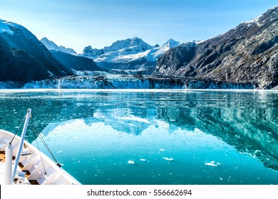 Cruise ship in Glacier Bay cruising towards Johns Hopkins Glacier in Alaska, USA. Panoramic view during summer. - Shutterstock ID 556662694