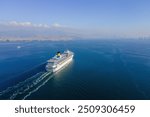 Cruise Ship Cruise Liner, white cruise ship above luxury cruise in the ocean sea at sunny day. Aerial