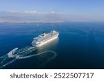 Cruise ship sailing across sea, Aerial, white cruise liner in a sunny day. Luxury cruise in the ocean sea concept tourism travel