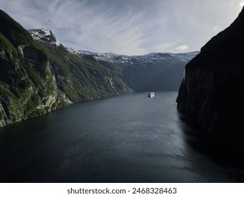 A cruise ship sailing through a fjord in Norway. Geiranger Fjord  - Powered by Shutterstock