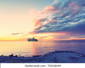 Cruise Ship Sails In The Baltic Sea Against The Sunset Dusk Background
