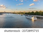 Cruise ship sails on the Moscow river in Moscow city center, popular place for walking. Panoramic view of Moscow river with cruise boat