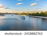 Cruise ship sails on the Moscow river in Moscow city center, popular place for walking. Panoramic view of Moscow river with cruise boat