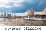 Cruise ship sails on the Moscow river in Moscow city center, popular place for walking. Panoramic view of Moscow river with cruise boat