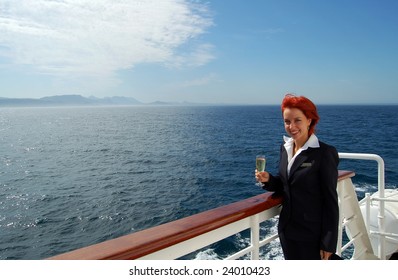 Cruise Ship Staff With A Glass Of Champagne Over An Ocean Background