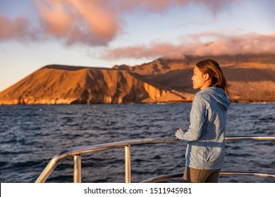 Cruise Ship Tourist On Boat Looking At Sunset Nature Landscape In Galapagos Islands.