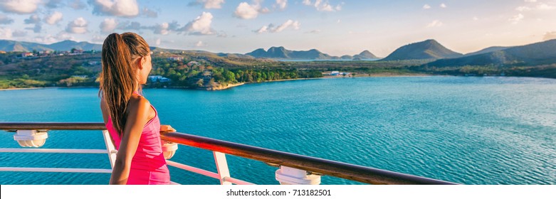 Cruise ship tourist woman Caribbean travel vacation banner. Panoramic crop of girl enjoying sunset view from boat deck leaving port of Basseterre, St. Lucia, tropical island.
