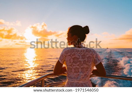 Cruise ship vacation woman watching sunset boat deck on summer travel. Silhouette of tourist relaxing on outdoor balcony of boat ferry.
