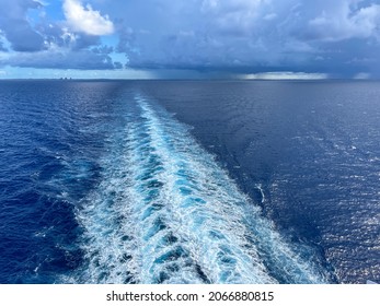 A Cruise Ship Wake On A Beautiful Stormy Day With Dark Clouds And Blue Seas On The Atlantic Ocean Sailing Away From Nassau, Bahamas.