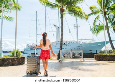 Cruise travel passenger going on board embarking ship with luggage suitcase. Woman tourist on Tahiti French Polynesia summer vacation.